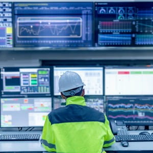 Engineer working at control room-Technician man monitoring program from a lot of monitors