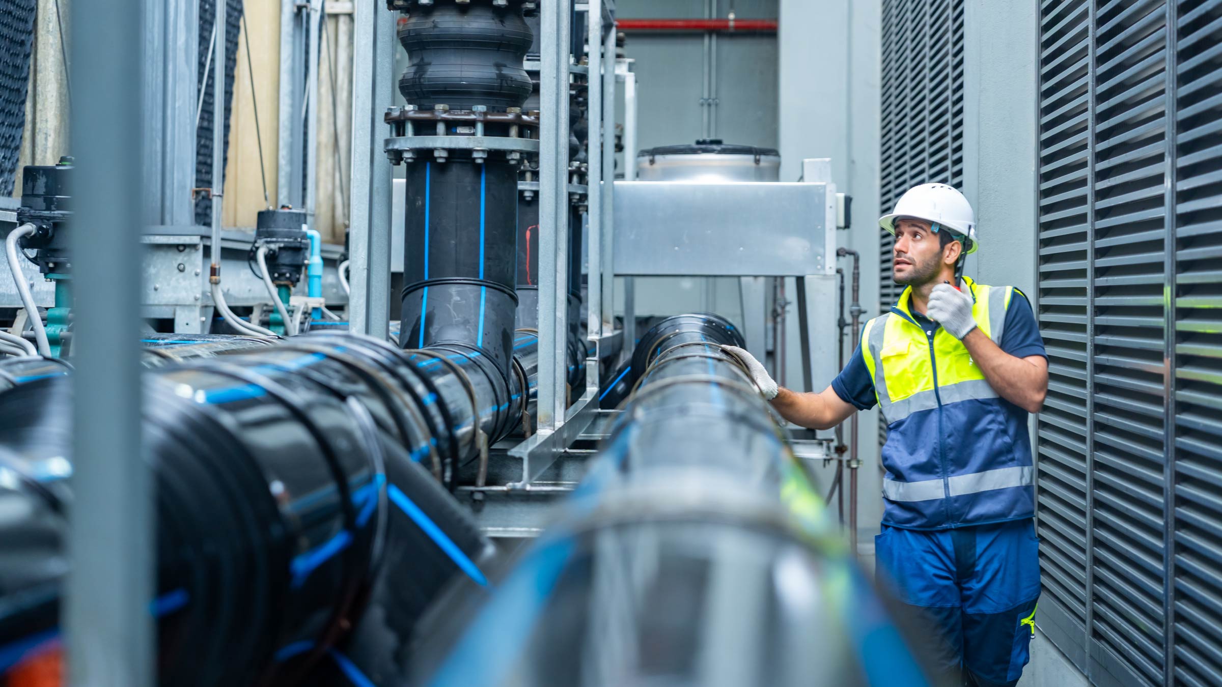 Industrial engineering technician working maintenance building plumbing systems